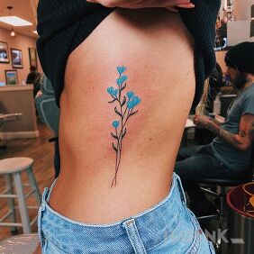 Tattoo Light blue flower on the ribs motif: flowers style: graphic / illustrative