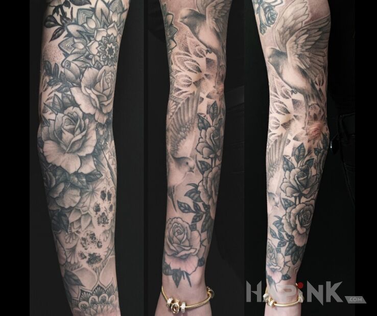 Tattoo Dove flowers sleeve in animals motif and blackwork / blackout style on the forearm