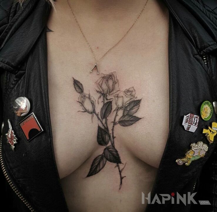 Tattoo 3 róże in black and gray motif and realistic style between the breasts