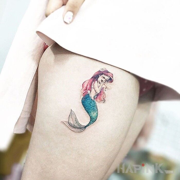 Tattoo Syrenka in characters motif on the leg