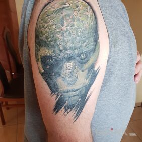 Tattoo Man On the arm motif: faces style: realistic