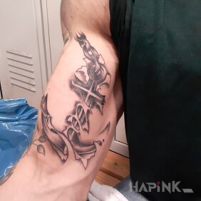 Tattoo Anchor on the bicep motif: ripped skin style: realistic