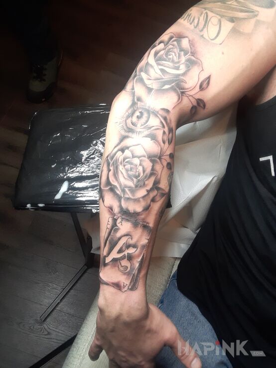 Tattoo Róże in black and gray motif and realistic style On the arm