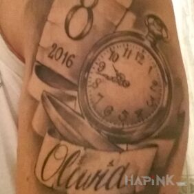 Tattoo Birth of a child on the upper arm motif: lettering style: realistic