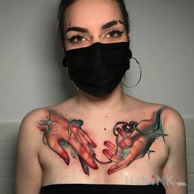 Tattoo Two hands on the collarbone motif: colorful style: realistic