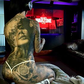 Tattoo Playing games on the back motif: black and gray style: realistic