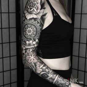 Tattoo Sleeve done tip top on the forearm motif: flowers style: geometric
