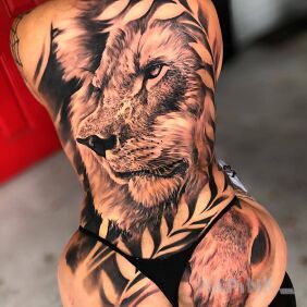 Tattoo Nasty lion on the buttocks motif: floral style: realistic