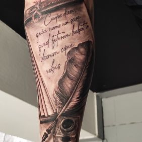Tattoo Inkwell with a pen quote on the forearm motif: lettering style: realistic