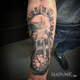 Tattoo Time through fingers on the forearm motif: objects style: realistic
