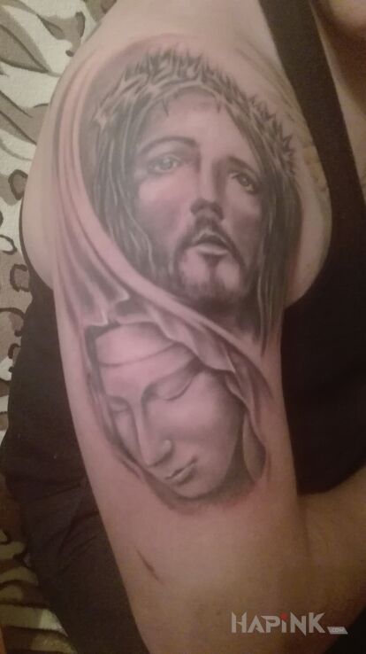 Tattoo Tatto in religious motif on the upper arm
