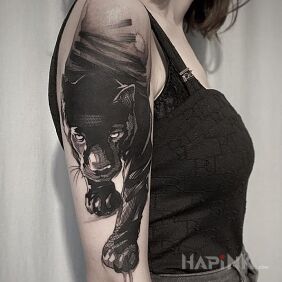 Tattoo Black jaguar On the arm motif: black and gray style: graphic / illustrative