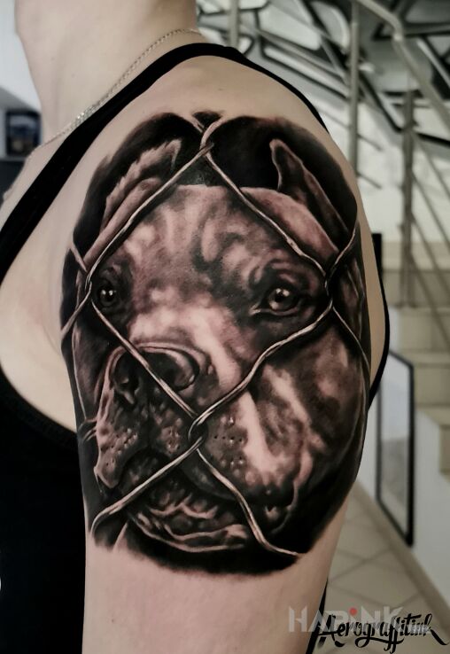 Tattoo Portret pupila in black and gray motif and realistic style on the upper arm