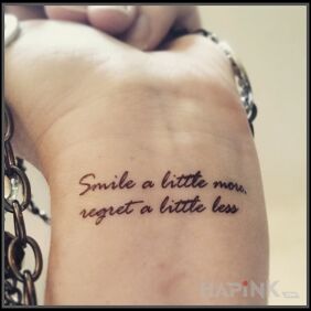 Tattoo More smile on the wrist motif: lettering style: calligraphy