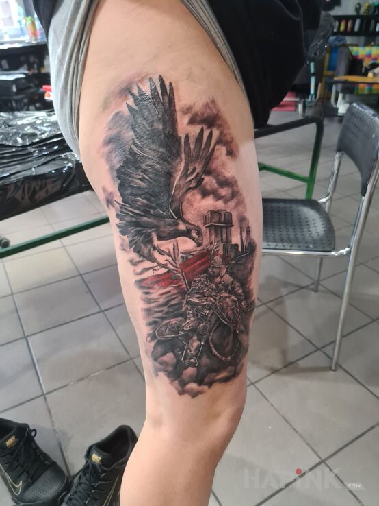 Tattoo Husaria Śląsk in black and gray motif and realistic style on the leg