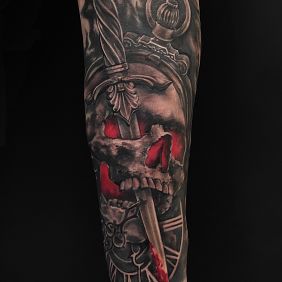 Tattoo Skull dagger On the arm motif: black and gray style: realistic