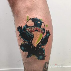 Tattoo StichVenom on the calf motif: colorful style: graphic / illustrative