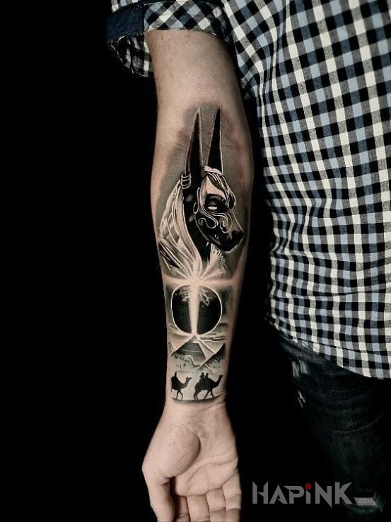 Tattoo Anubis in characters motif and realistic style on the forearm