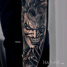 Tattoo Joker On the arm motif: faces style: realistic