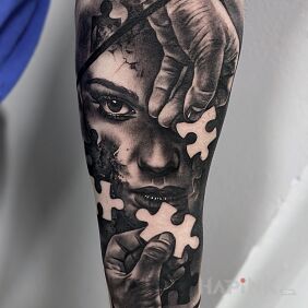 Tattoo Puzzle on the forearm motif: black and gray style: realistic