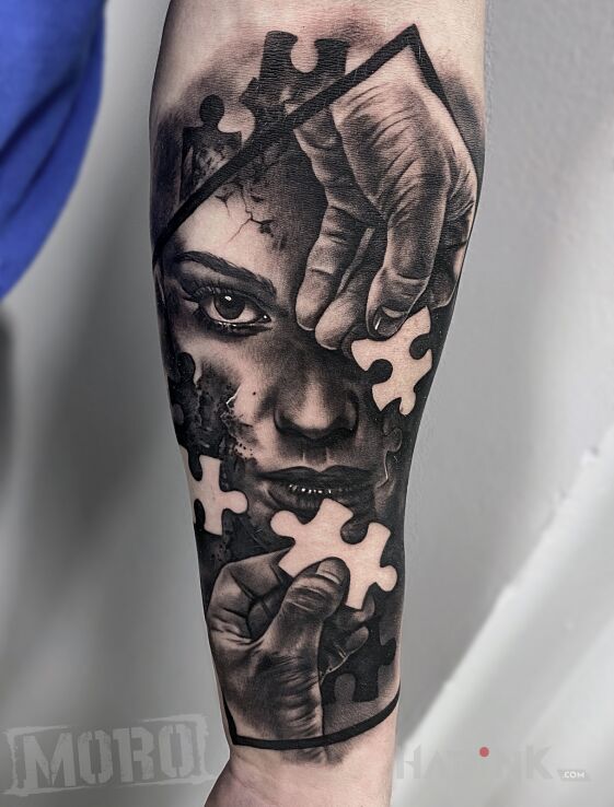 Tattoo Puzzle in faces motif and realistic style on the forearm