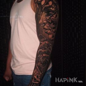Tattoo Female face on the upper arm motif: black and gray style: realistic
