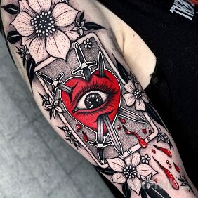 Tattoo Daggers stuck in the heart on the upper arm motif: flowers style: graphic / illustrative