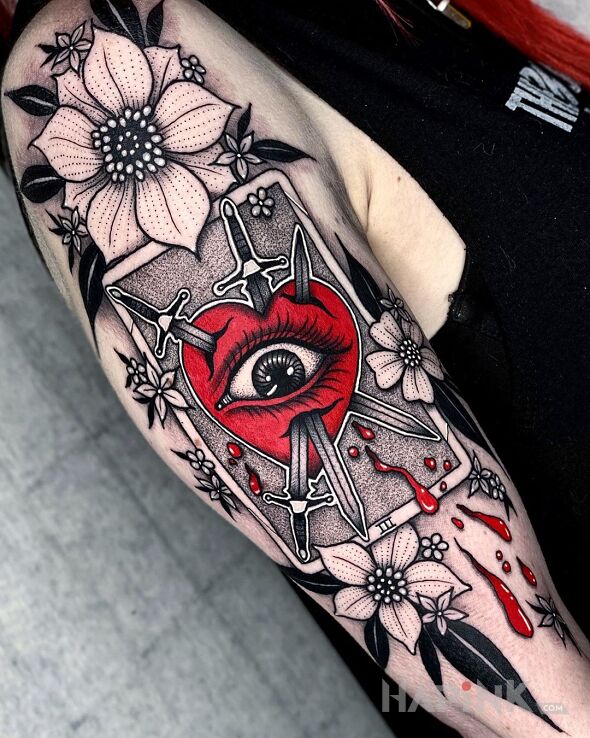 Tattoo Sztylety wbite w serce in black and gray motif and graphic / illustrative style on the upper arm