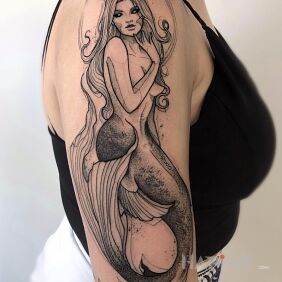 Tattoo Horned mermaid on the upper arm motif: black and gray style: graphic / illustrative