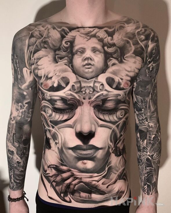 Tattoo Aniołek Boży in faces motif and realistic style on the upper arm