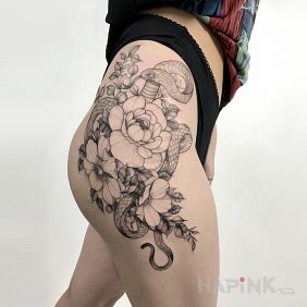 Tattoo Composition with flowers and a snake on the buttocks motif: nature style: graphic / illustrative