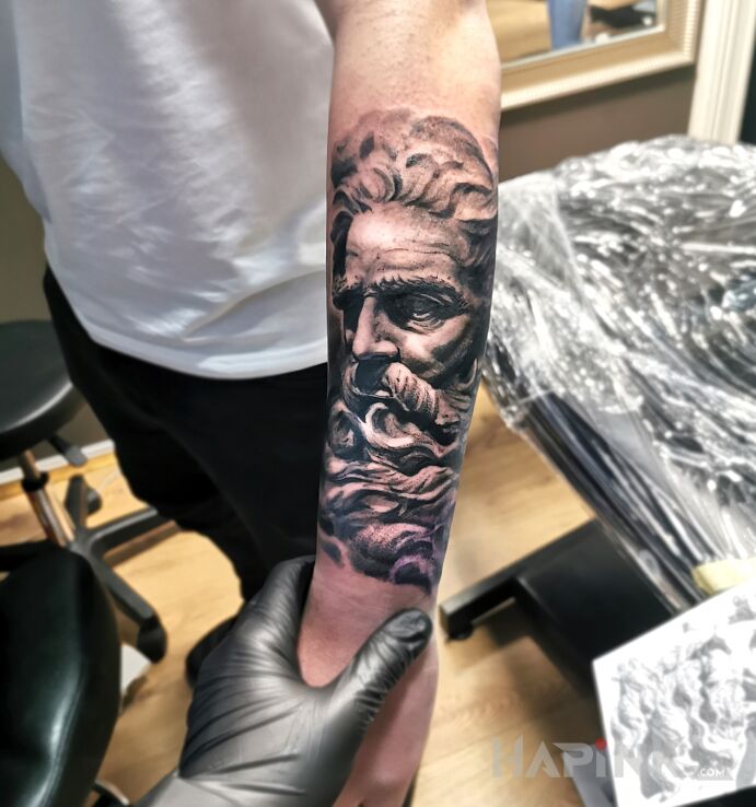 Tattoo Posejdon in black and gray motif and realistic style On the arm