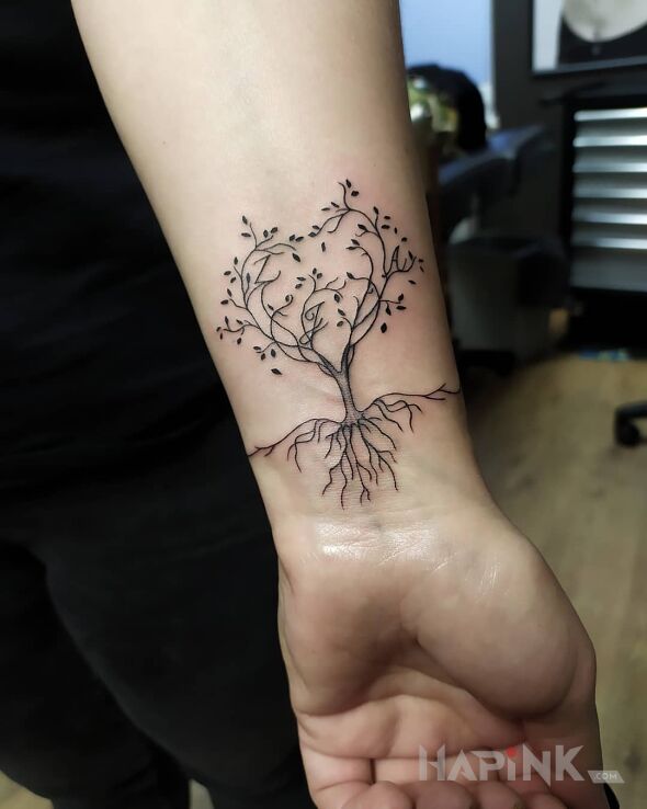 Tattoo Drzewo z literami in floral motif and graphic / illustrative style on the wrist
