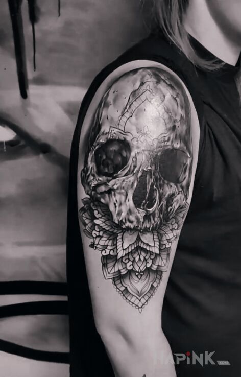 Tattoo Czaszka plus mandala in black and gray motif and realistic style on the upper arm
