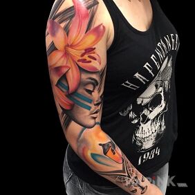 Tattoo Woman with a large colorful flower On the arm motif: faces style: realistic