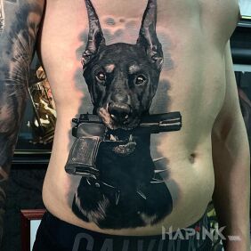 Tattoo Doberman with a gun on the ribs motif: animals style: realistic