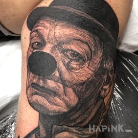 Tattoo Sad clown. on the upper arm motif: faces style: realistic