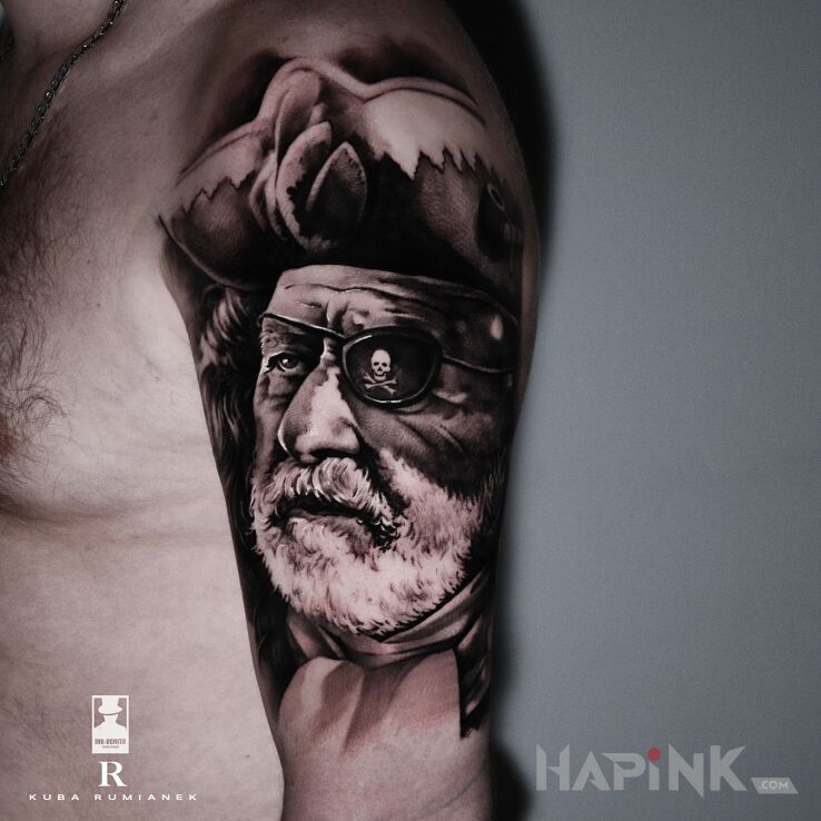 Tattoo Pirat in faces motif and realistic style on the upper arm