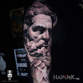 Tattoo Zeus on the upper arm motif: faces style: realistic