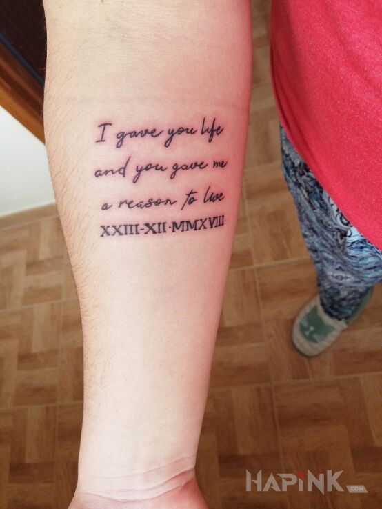 Tattoo Life for live in lettering motif and calligraphy style On the arm