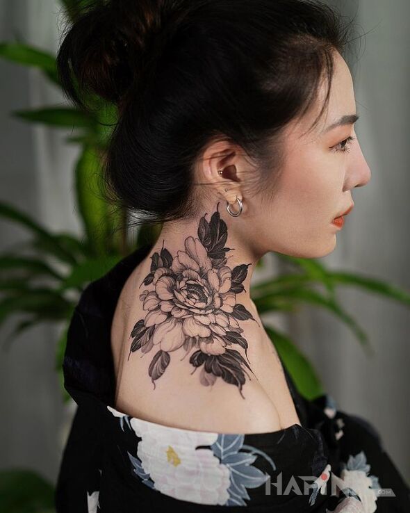Tattoo Piwonia in floral motif and realistic style on the shoulder