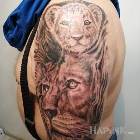 Tattoo Lion On the arm motif: black and gray style: realistic