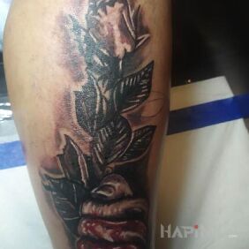 Tattoo Rose on the leg motif: black and gray style: realistic