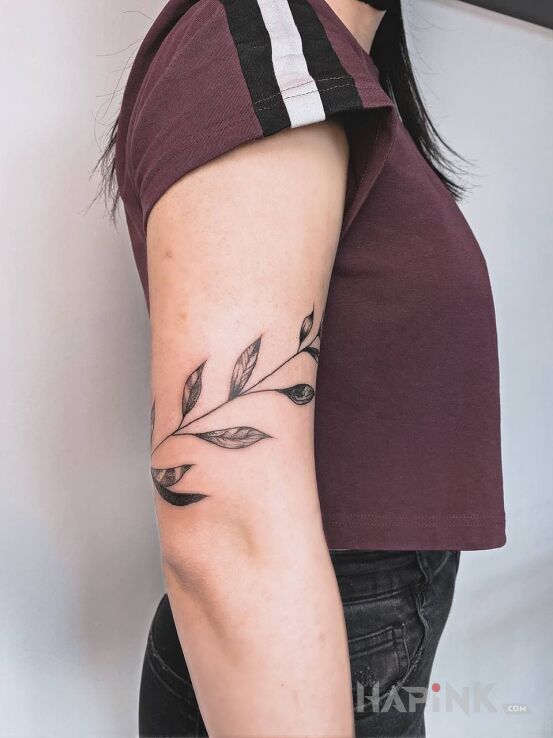 Tattoo Listki in flowers motif and graphic / illustrative style on the upper arm
