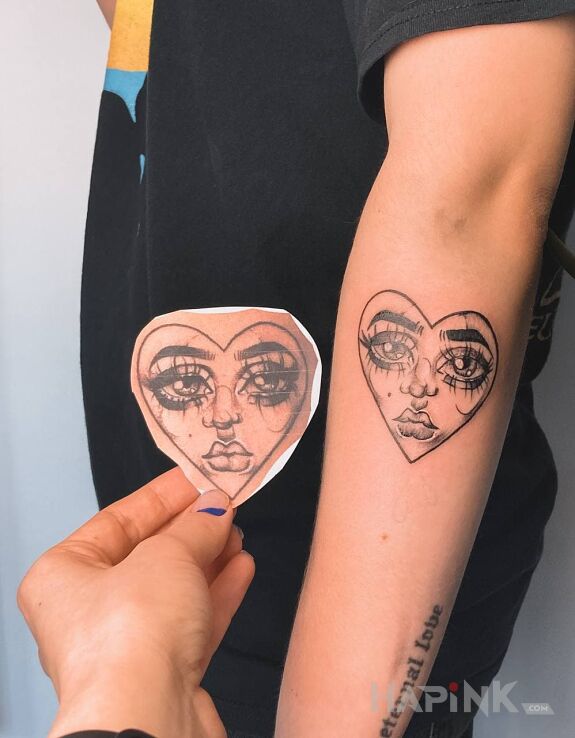 Tattoo Serduszko in faces motif and graphic / illustrative style On the arm
