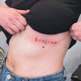 Tattoo Colorful bonjour inscription on the ribs motif: colorful