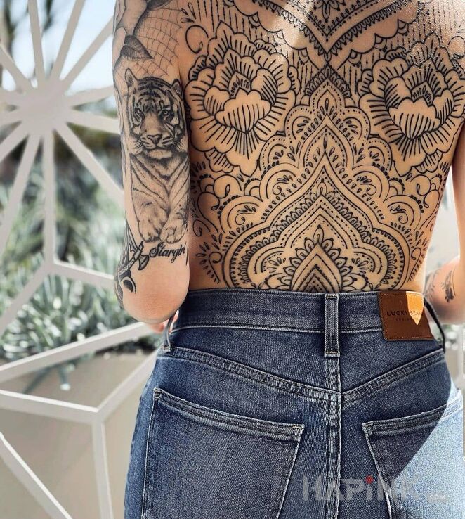 Tattoo Ozdobione plecy in black and gray motif and realistic style On the arm