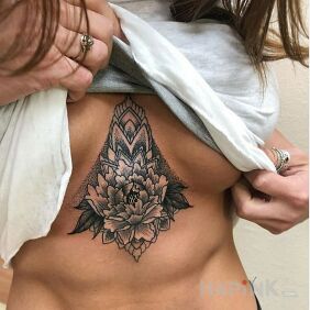 Tattoo Peony on a toned abdomen underboob motif: black and gray style: graphic / illustrative