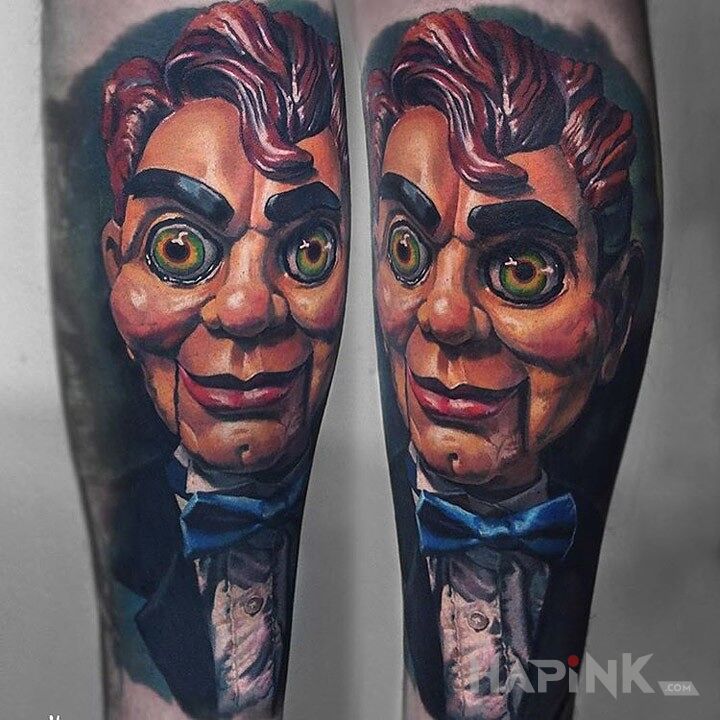 Tattoo Lalka brzuchomówcy in characters motif on the forearm