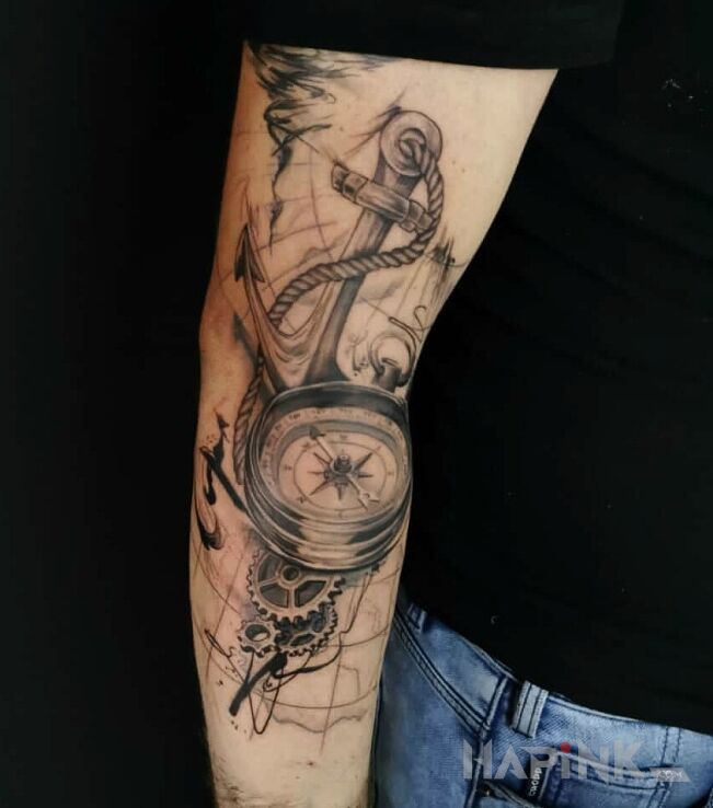 Tattoo Anchor compass map in objects motif and realistic style On the arm